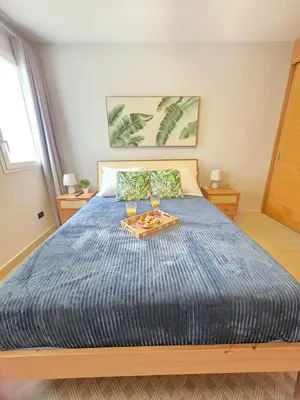 a bedroom with a bed with two glasses on it at Caribbean Comfort near the Sea l Cefiro 101 in La Laguna