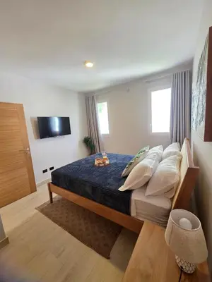 a bedroom with a bed with a blue comforter at Caribbean Comfort near the Sea l Cefiro 101 in La Laguna