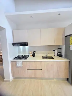 a kitchen with a sink and a stove top oven at Garden Breeze Penthouse & Pool View l Mistral 401 in La Laguna