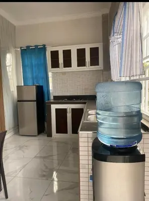a kitchen with a stack of blue containers in a room at Apartamento de recreación vista al mar in Boca Chica