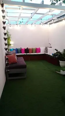 a living room with a couch in a room with grass at Hotel en Pedernales in Pedernales