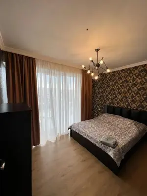 a bedroom with a bed and a large window at Hotel en Pedernales in Pedernales