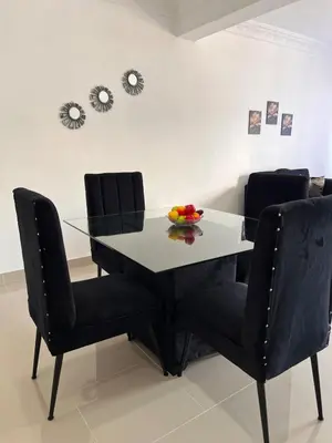 a dining room table and chairs with a bowl of fruit on it at Luxury Royalty-1 in Santa Cruz de Barahona