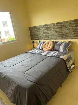 a bedroom with a large bed with a large headboard at Olas del caribe DR in Santo Domingo