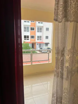 a window with a view of a building at Olas del caribe DR in Santo Domingo