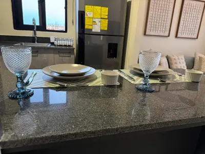 a counter with two wine glasses and plates on it at Hermoso PUNTA CANA VISTA CANA in Colorado