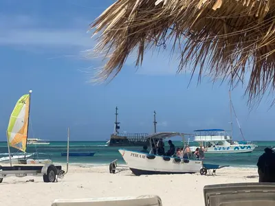 a group of people in a boat on the beach at Cocotal Beach Pool and Golf course Punta Cana RD in Colorado