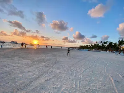 a group of people on a beach at sunset at Cocotal Beach Pool and Golf course Punta Cana RD in Colorado
