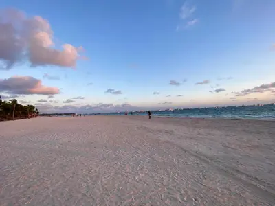 a beach with a group of people walking on it at Cocotal Beach Pool and Golf course Punta Cana RD in Colorado