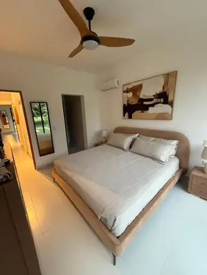 a bedroom with a bed with a ceiling fan at Cocotal Beach Pool and Golf course Punta Cana RD in Colorado