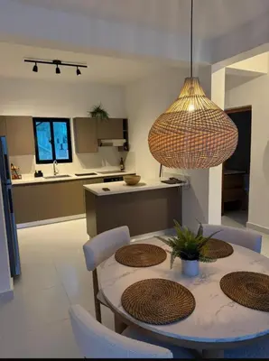 a kitchen and dining room with a table with chairs at Cocotal Beach Pool and Golf course Punta Cana RD in Colorado