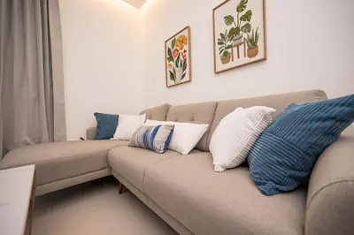 a living room with a couch with pillows on it at Santiago s top Residence, Experience it & Believe it in Santiago de los Caballeros