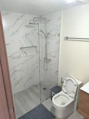 a bathroom with a toilet and a glass shower at RIKI R Boca del Mar III Apartment 406 in Boca Chica