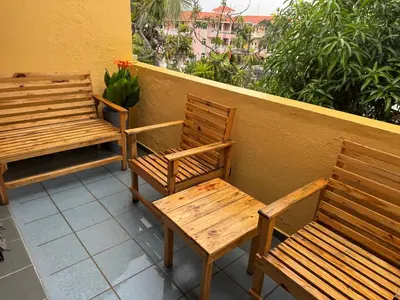 two wooden benches sitting on top of a balcony at Costa Lunga-Tropicasa in Boca Chica