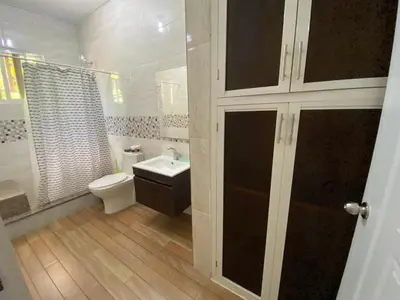 a white bathroom with a toilet and a sink at Casa veraniega en samana in Santa Bárbara de Samaná