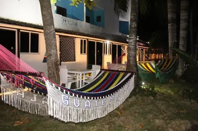 a couple of hammocks in front of a house at Aparta Hotel Azzurra in Boca Chica