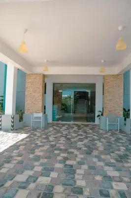 an empty lobby with a stone floor and glass doors at Vista Marina Residence in Boca Chica