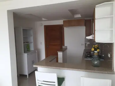 a kitchen with white cabinets and a counter top at Vista Marina Residence in Boca Chica