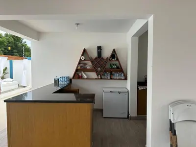 a kitchen with a counter and a refrigerator at Residencial HH in Santiago de los Caballeros
