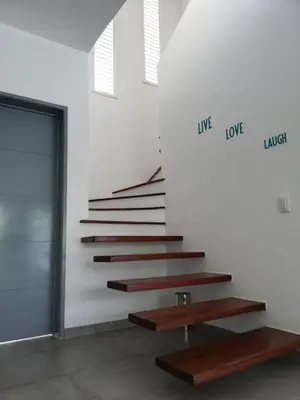 a set of stairs in a room with a door at Villas Riviera in Las Terrenas
