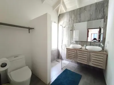 a bathroom with a toilet and a sink and a mirror at Villas Riviera in Las Terrenas