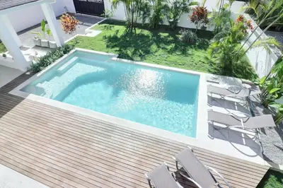 an overhead view of a swimming pool with chairs at Villas Riviera in Las Terrenas