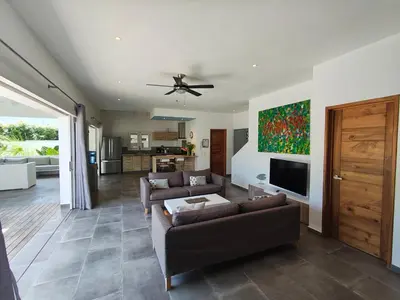 a living room with two couches and a ceiling fan at Villas Riviera in Las Terrenas