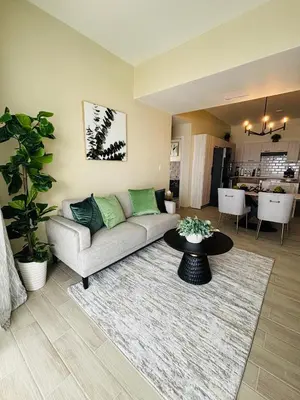 a living room with a couch and a table at Apartment Punta Cana Oasis ONA Residences in Punta Cana