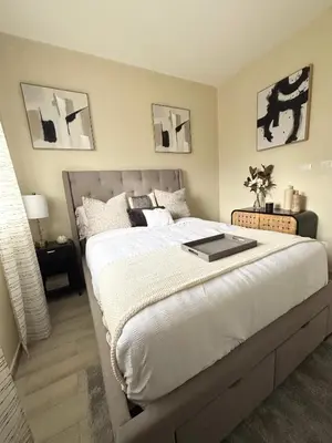a bedroom with a large bed with a book on it at Apartment Punta Cana Oasis ONA Residences in Punta Cana