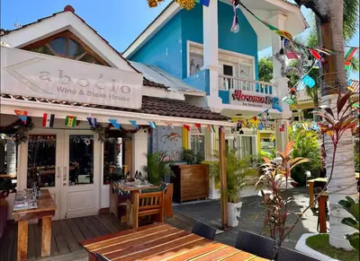 a restaurant with a table and chairs in front of a building at Apartment Punta Cana Oasis ONA Residences in Punta Cana