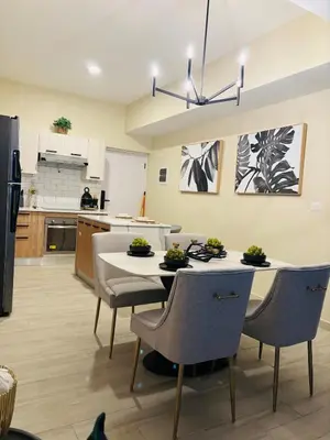 a kitchen with a table and chairs in a room at Apartment Punta Cana Oasis ONA Residences in Punta Cana