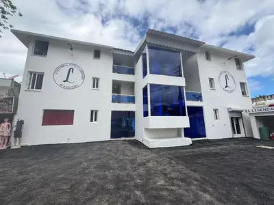 a large white building with people standing in front of it at El Legendario in Sosúa
