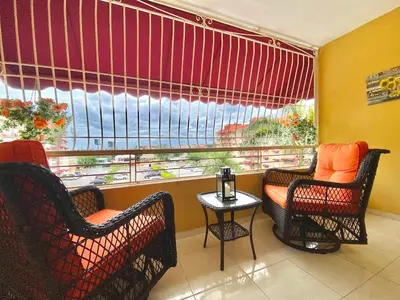 a room with two chairs and a window with a view at Stylish 3BR Condo, Full AC, Wi-Fi in Santo Domingo