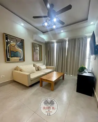 a living room with a couch and a table at Boca del Mar III Apartment 724 in Boca Chica