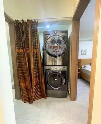 a washer and dryer in a room next to a door at Boca del Mar III Apartment 724 in Boca Chica