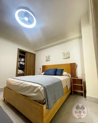a bedroom with a bed with a ceiling fan at Boca del Mar III Apartment 724 in Boca Chica