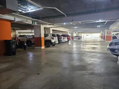 an empty parking garage with cars parked in it at Boca del Mar III Apartment 724 in Boca Chica