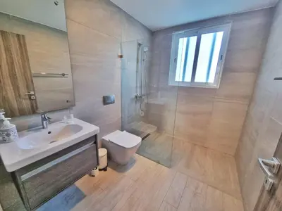 a bathroom with a shower and a sink and a toilet at Aqua Pearl ! Pool Access 2 BRM J 102 in Punta Cana