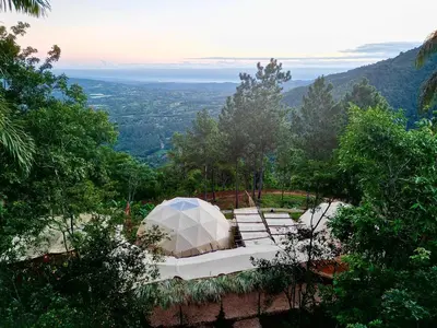 a white tent sitting on top of a hill at Eco Domes Couples Getaway - Waterfall and Mountain Views in Jarabacoa