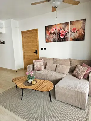a living room with a couch and a coffee table at Estrella Garden Condos Dominicus l Meridiana 204 in La Laguna