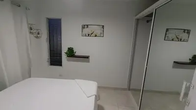 a white room with a bed and a window at Apartamento palmera del este 3 in La Javilla