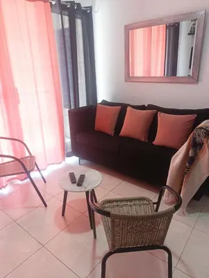 a living room with a couch and chairs and a table at Apartamento palmera del este 3 in La Javilla