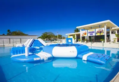 a pool with a water slide in a mall at Laguna Park Apartments in Sosúa
