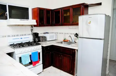 a kitchen with white appliances and a white refrigerator at Apartamento en el malecón cerca de la playa in San Felipe de Puerto Plata