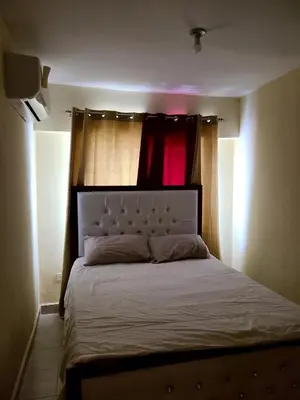 a bedroom with a bed in a room with a window at Apartment5Start in Santo Domingo