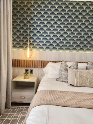 a bedroom with a bed and a nightstand and a wall at Luxury Beachside Retreat & Private Plunge Pool in Punta Cana