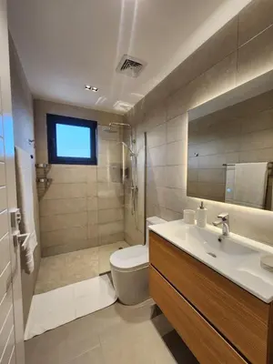 a bathroom with a toilet and a sink at Luxury Beachside Retreat & Private Plunge Pool in Punta Cana