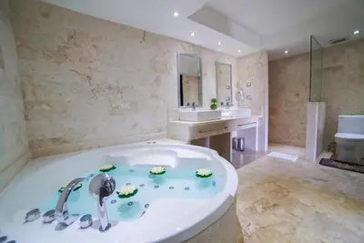 a large bathroom with a tub and a sink at LTH Las Terrenas Hotel in Las Terrenas