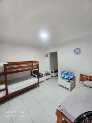 a bedroom with two bunk beds and a flat screen tv at Hogar cerca de la playa in Punta Cana