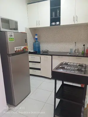 a kitchen with a refrigerator and a stove at Hogar cerca de la playa in Punta Cana